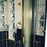 CUSTOM GLASS BLOCK SHOWER WITH SEAT.